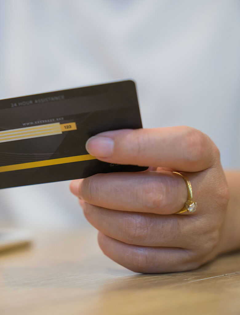 man with gold ring paying with credit card